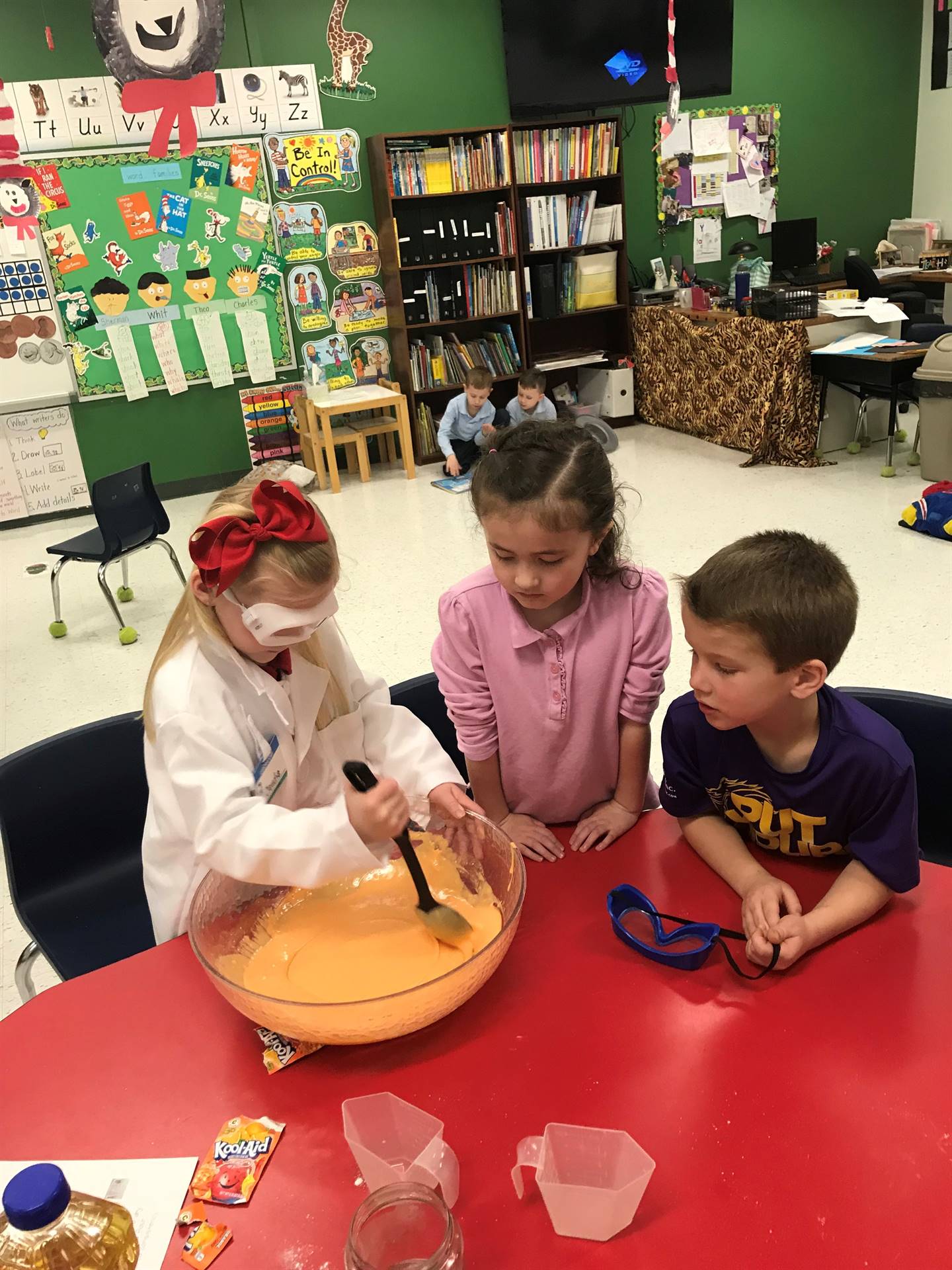 Kindergarteners mixing something in a bowl