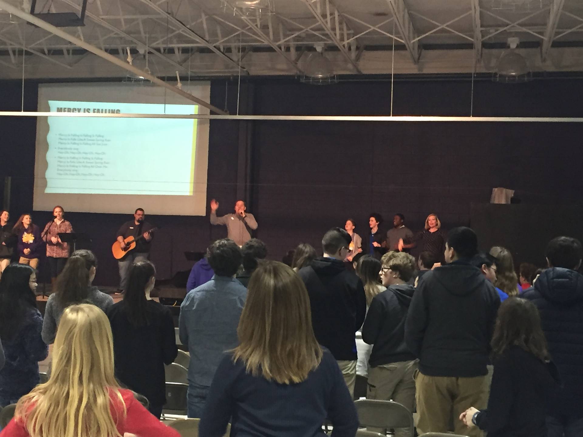 Students and teachers in a chapel service