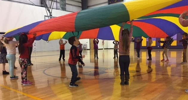 Preschool Students playing with a parachute