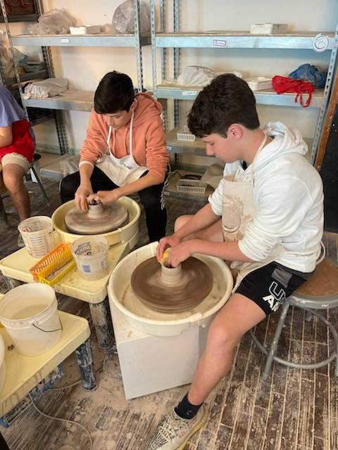 Students creating pottery