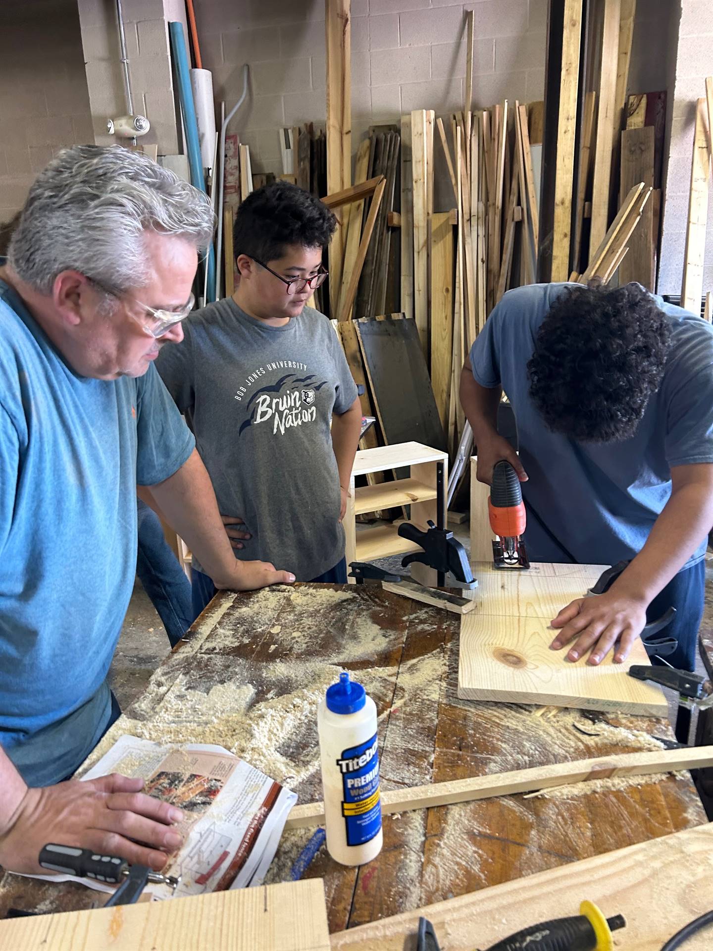 Mr. Scheidt working with woodworking students